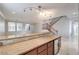 Open-concept living space featuring granite countertop, breakfast bar, and staircase at 7095 Mountain Den Ave, Las Vegas, NV 89179