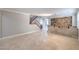 Spacious open-concept living room with tile floors, staircase, and a stone accent wall at 7095 Mountain Den Ave, Las Vegas, NV 89179