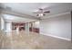 Bright living room with travertine floors, ceiling fan, and kitchen view at 7095 Mountain Den Ave, Las Vegas, NV 89179