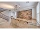 Beautiful living area featuring tiled flooring, stone accent wall, breakfast bar, and staircase at 7095 Mountain Den Ave, Las Vegas, NV 89179