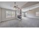 Spacious living room with ceiling fan, fireplace, and abundant natural light at 7095 Mountain Den Ave, Las Vegas, NV 89179