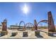 Mountain's Edge Regional Park entrance with arches, sculptures, and seating areas under a sunny sky at 7095 Mountain Den Ave, Las Vegas, NV 89179