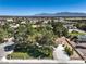 Beautiful aerial shot of desert home with luscious green lawn and mature shade trees at 7460 Buckskin Ave, Las Vegas, NV 89129