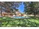 Spacious backyard featuring a pool, patio, and well-maintained lawn at 7460 Buckskin Ave, Las Vegas, NV 89129