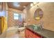 Charming bathroom with decorative tiles, a glass vessel sink, and a shower-tub combination at 7460 Buckskin Ave, Las Vegas, NV 89129
