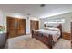 Comfortable bedroom with ample closet space, a cozy bed, and a bright window at 7460 Buckskin Ave, Las Vegas, NV 89129