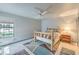 Bedroom features a wood frame bed, a ceiling fan, natural light, and stylish decor at 7460 Buckskin Ave, Las Vegas, NV 89129