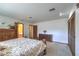 Bedroom view showcasing closet space, access to a bathroom, and neutral décor at 7460 Buckskin Ave, Las Vegas, NV 89129
