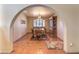 Charming dining room offering a classic chandelier, a large window, and a view of the living room at 7460 Buckskin Ave, Las Vegas, NV 89129