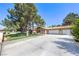 Spacious home with a large driveway and well-manicured lawn, perfect for Gathering living at 7460 Buckskin Ave, Las Vegas, NV 89129