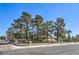 Inviting home with a well-maintained lawn, mature trees, and a classic brick fence at 7460 Buckskin Ave, Las Vegas, NV 89129