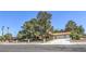 Lovely single-story home with a large mature trees, complemented by a well-kept yard and a long driveway at 7460 Buckskin Ave, Las Vegas, NV 89129