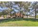 Beautifully landscaped front yard with mature trees, lush green lawn, and a well-maintained exterior at 7460 Buckskin Ave, Las Vegas, NV 89129