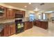 Traditional kitchen features granite counters, tiled backsplash, custom cabinets, and stainless steel appliances at 7460 Buckskin Ave, Las Vegas, NV 89129