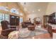 Open living room boasts a high ceiling, a cozy fireplace, and an abundance of natural light at 7460 Buckskin Ave, Las Vegas, NV 89129