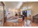 Inviting living room featuring hardwood floors, a comfortable seating area, and a view of the dining room at 7460 Buckskin Ave, Las Vegas, NV 89129