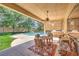Covered patio with dining set, lounge seating, and view of the pool at 7460 Buckskin Ave, Las Vegas, NV 89129
