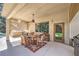 A charming covered patio with a dining set and ceiling fan, ideal for relaxing and enjoying outdoor meals at 7460 Buckskin Ave, Las Vegas, NV 89129
