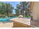 Outdoor kitchen with bar and grill near the beautiful backyard pool at 7460 Buckskin Ave, Las Vegas, NV 89129