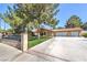 Charming house featuring desert landscaping, secured by a wall and gate for added privacy at 7460 Buckskin Ave, Las Vegas, NV 89129
