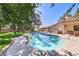 Serene backyard featuring a sparkling swimming pool, built-in grill and a covered patio for outdoor relaxation at 7460 Buckskin Ave, Las Vegas, NV 89129