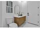 Stylish bathroom with sleek fixtures, marble countertop, wood cabinetry, and a modern mirror at 7738 Willow Cove Cir, Las Vegas, NV 89129