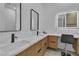Bright bathroom featuring double sinks, modern fixtures, and a vanity area with a stylish, lighted mirror at 7738 Willow Cove Cir, Las Vegas, NV 89129