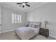 Cozy bedroom with neutral walls, carpet, ceiling fan, and plenty of natural light at 7738 Willow Cove Cir, Las Vegas, NV 89129