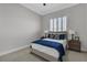 Cozy bedroom with shutters, ceiling fan, and a comfortable bed flanked by nightstands and lamps at 7738 Willow Cove Cir, Las Vegas, NV 89129