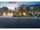 Beautiful single-story home featuring a three-car garage and desert landscaping at 7738 Willow Cove Cir, Las Vegas, NV 89129