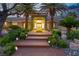 Inviting front entrance with palm trees, stone landscaping, and outdoor lighting at 7738 Willow Cove Cir, Las Vegas, NV 89129