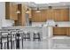 Modern kitchen featuring wood cabinets, stainless appliances, large island, and marble floors at 7738 Willow Cove Cir, Las Vegas, NV 89129