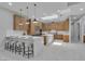 Modern kitchen with wood cabinets, stainless appliances, large island, and marble floors at 7738 Willow Cove Cir, Las Vegas, NV 89129