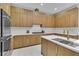 Updated kitchen with stainless steel appliances, wood cabinets, and stone countertops at 7738 Willow Cove Cir, Las Vegas, NV 89129