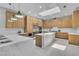 Spacious kitchen featuring wood cabinets, stainless appliances, island, and marble counters at 7738 Willow Cove Cir, Las Vegas, NV 89129