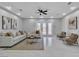 Bright living room with modern furniture, tile floors, and doors to the backyard at 7738 Willow Cove Cir, Las Vegas, NV 89129