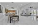 Open-concept living space with dining, kitchen, and living areas and natural light at 7738 Willow Cove Cir, Las Vegas, NV 89129