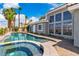 Backyard pool and spa with palm trees, a brick surround and a home exterior at 7738 Willow Cove Cir, Las Vegas, NV 89129