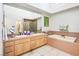 Large bathroom with a double sink vanity, soaking tub, and a separate shower stall at 8236 Round Hills Cir, Las Vegas, NV 89113