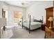 Bright bedroom with a ceiling fan, neutral carpet, and a glass sliding door leading to a patio at 8236 Round Hills Cir, Las Vegas, NV 89113