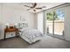 Cozy bedroom with a ceiling fan, and sliding glass door leading to a private patio at 8236 Round Hills Cir, Las Vegas, NV 89113