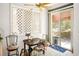 Cozy breakfast nook with a wooden table, chairs, bright windows, and sliding door to a patio at 8236 Round Hills Cir, Las Vegas, NV 89113