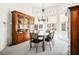 Spacious dining room with a glass table, six chairs, and built-in wood cabinets for ample storage at 8236 Round Hills Cir, Las Vegas, NV 89113