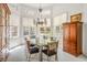 Bright dining room with a large glass table, six chairs, and lots of natural light from the surrounding windows at 8236 Round Hills Cir, Las Vegas, NV 89113