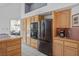 Well-equipped kitchen with wood cabinets, stainless steel appliances, and tiled countertops at 8236 Round Hills Cir, Las Vegas, NV 89113