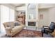 Cozy living room featuring a fireplace, plush seating, and decorative rug at 8236 Round Hills Cir, Las Vegas, NV 89113