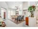 Bright living room with high ceilings, fireplace, comfortable seating, and ample natural light at 8236 Round Hills Cir, Las Vegas, NV 89113