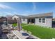 Spacious backyard with manicured lawn, modern patio furniture, and outdoor dining area at 832 Canonbury St, Henderson, NV 89011