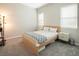 Bedroom with neutral walls, two windows, and bed with white and navy linens at 832 Canonbury St, Henderson, NV 89011