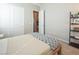 Bedroom with neutral walls, bed with white and navy linens, and decorative bookshelf at 832 Canonbury St, Henderson, NV 89011
